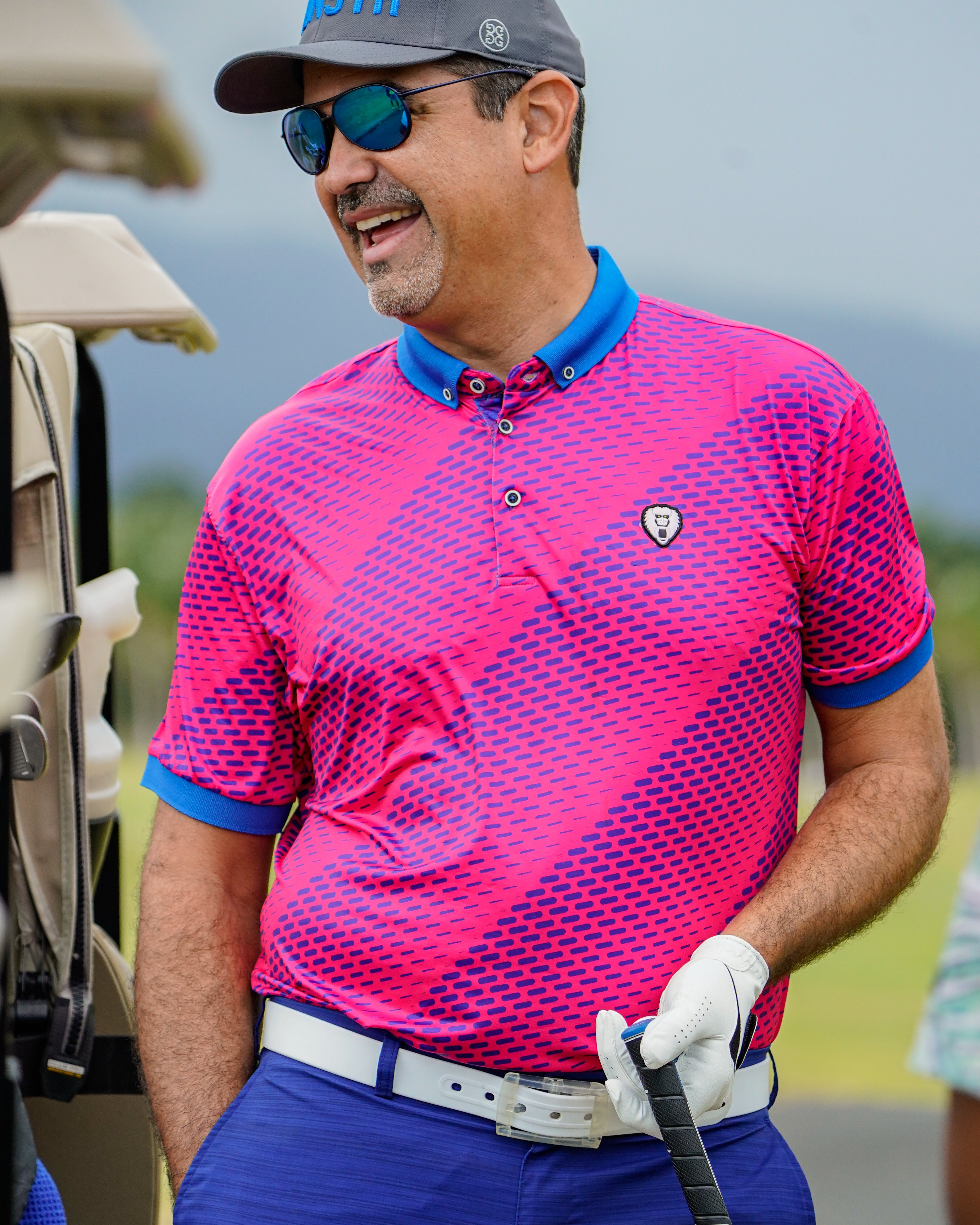 A man wearing Mad Chuck golf  pink polo.
